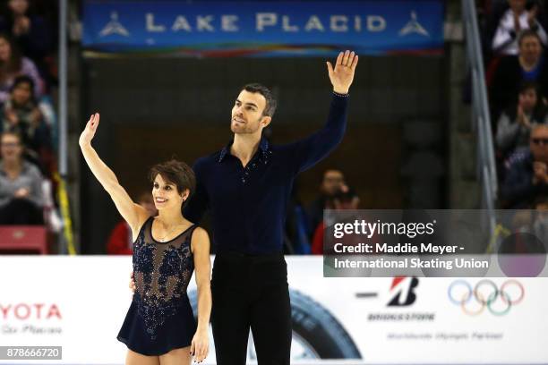 Meagan Duhamel and Eric Radford of Canada wave to fans after their performance during the Pairs Short program on Day 1 of the ISU Grand Prix of...