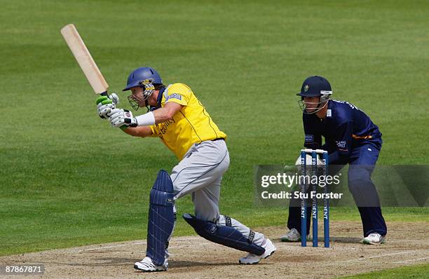 Derbyshire batsman Stuart Law picks up some runs watched by Glamorgan wicketkeeper Mark Wallace during the Friends Provident Trophy match between...