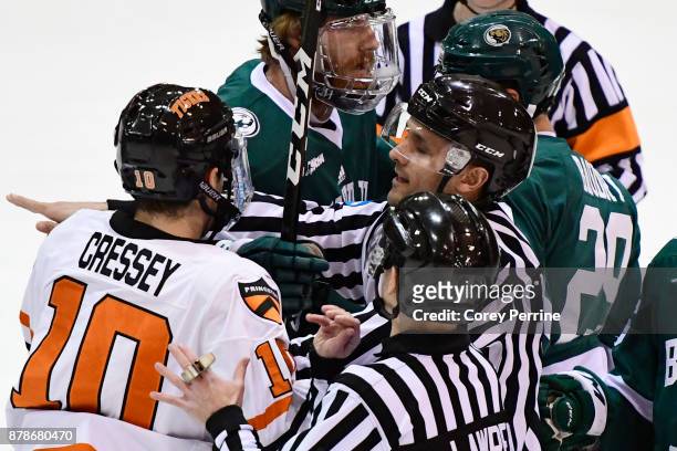 Jackson Cressey of the Princeton Tigers and Justin Baudry of the Bemidji State Beavers are broken up by referees after a little bit of shoving during...