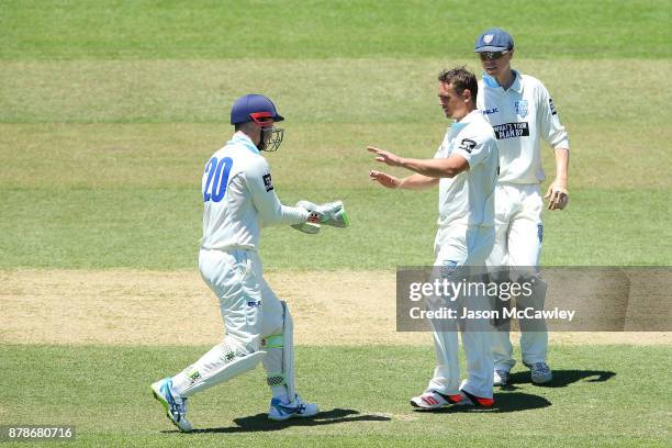 Stephen O'Keefe of NSW is congratulated by Peter Nevill after dismissing Glenn Maxwell of Victoria during day two of the Sheffield Shield match...