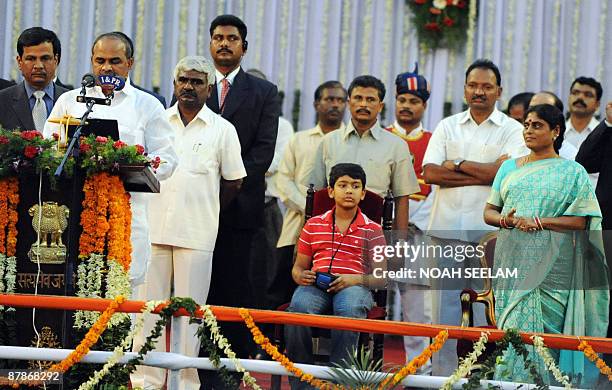 Southern Indian state Andhra Pradesh's Chief Minister Y. S. Rajasekhara Reddy takes the oath of office and secrecy as his wife Vijayalakshmi looks on...