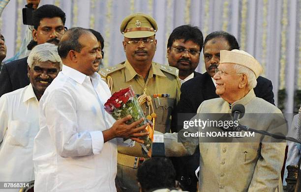 Southern Indian state Andhra Pradesh's Chief Minister Y. S. Rajasekhara Reddy is greeted by Governor N. D. Tiwari after taking the oath of office and...