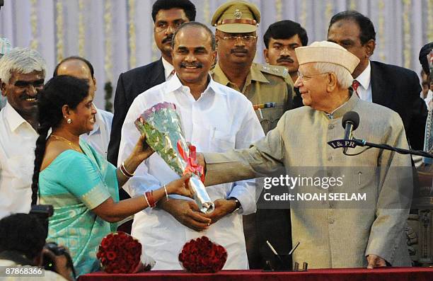 Southern Indian state Andhra Pradesh's Chief Minister Y. S. Rajasekhara Reddy looks on as the Governor N. D. Tiwari greets his wife VijayaLakshmi at...