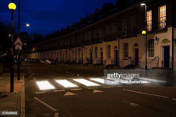 glowing zebra-crossing in urban setting - hazard sign stock pictures, royalty-free photos & images