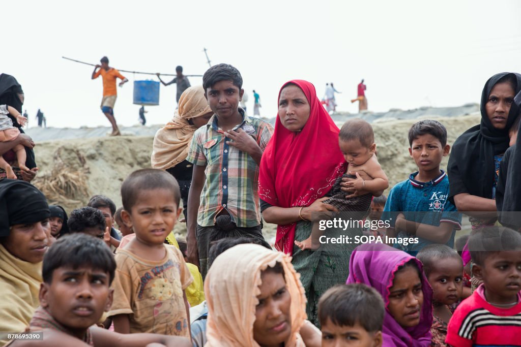 Rohingya refugees sit waiting to be taken to registration...