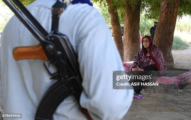 This photograph taken on September 27 shows Pakistani woman Mukhtiar Naz , known as Waderi Nazo Dharejo, meeting with workers near her home in Qazi...