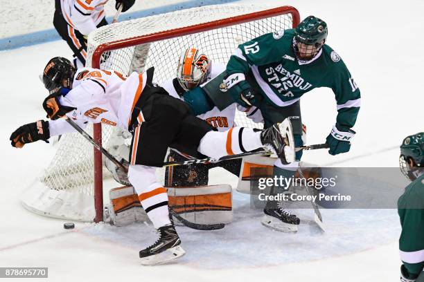 Derek Topatigh of and Ryan Ferland of the Princeton Tigers keep the puck from Dylan McCrory of the Bemidji State Beavers during the second period at...