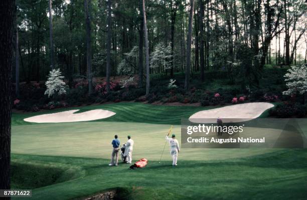 Seve Ballesteros waits as Larry Mize putts on the 13th green during the 1987 Masters Tournament at Augusta National Golf Club in April 1987 in...