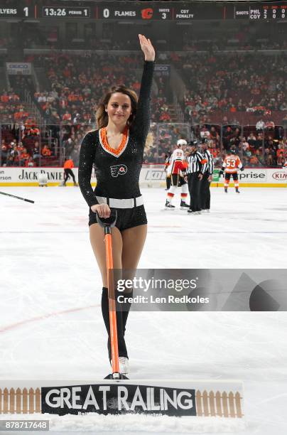 Member of the Philadelphia Flyers ice girls waves to the crowd as she cleans the ice during a timeout against the Calgary Flames on November 18, 2017...