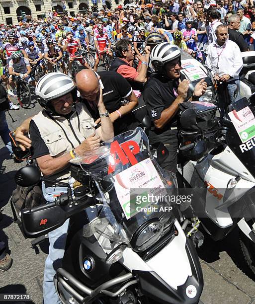 Italian photographer Roberto Bettini is comforted by a moto rider as a minute of silence is held to pay respect to photographer's motorbike pilot...