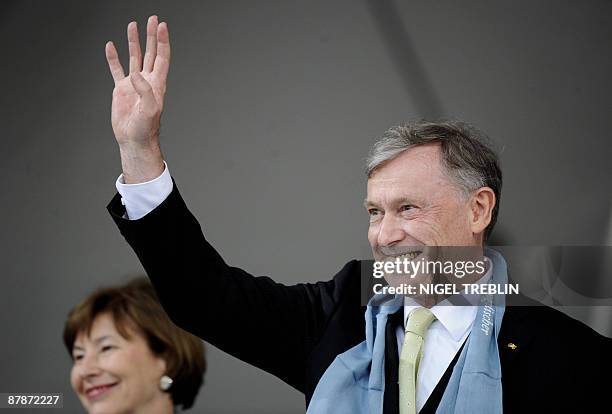 German President Horst Koehler waves as he and his wife Eva Luise attend the opening of a protestant church congress in the northern German city of...