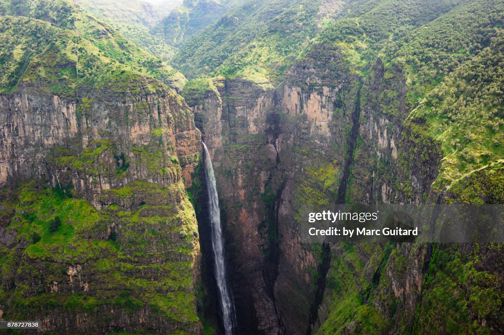Wide angle shot of Jinbar Waterfall tumbling into the Geech Abyss, Simien Mountains National Park, Ethiopia