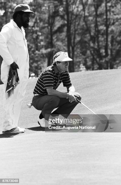 Johnny Miller and his caddie read his putt during the 1980 Masters Tournament at Augusta National Golf Club on April 1980 in Augusta, Georgia.