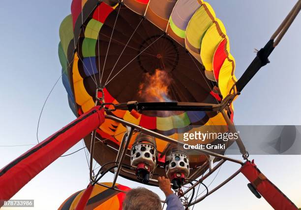 pilot inflating the hot air balloon. preparing for takeoff. - hot air ballon foto e immagini stock
