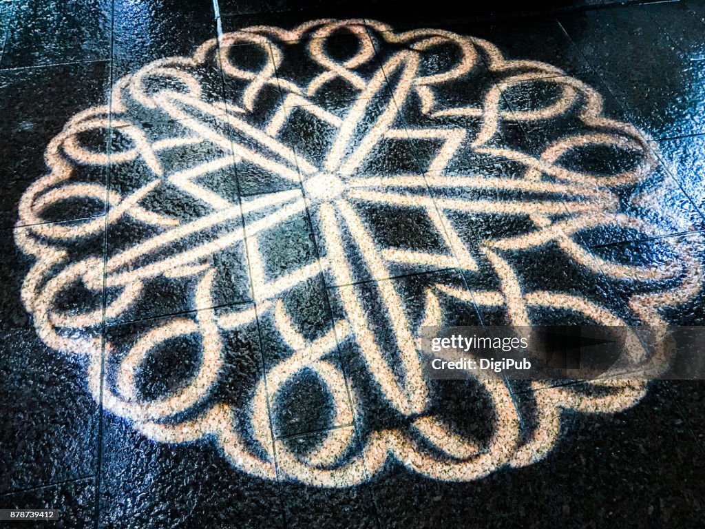 Projection on pedestrian pathway, in the rainy night