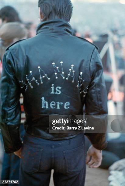 Back view of an unidentified man who wears a leather jacket that reads 'Sha Na Na Is Here' at the Woodstock Music and Arts Fair in Bethel, New York,...