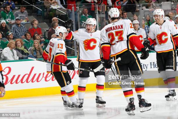 Johnny Gaudreau, Michael Ferland, Sean Monahan and Dougie Hamilton of the Calgary Flames celebrate a goal against the Dallas Stars at the American...