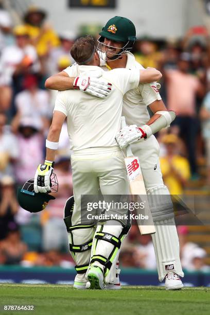 Steve Smith of Australia embraces Pat Cummins of Australia as he celebrates his century during day three of the First Test Match of the 2017/18 Ashes...
