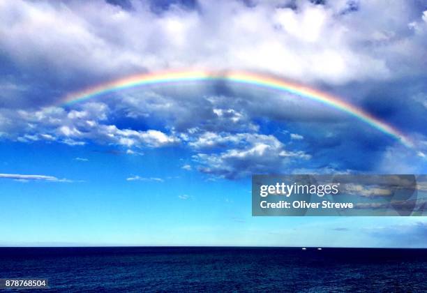 rainbow in clouds - rainbow sky stock pictures, royalty-free photos & images