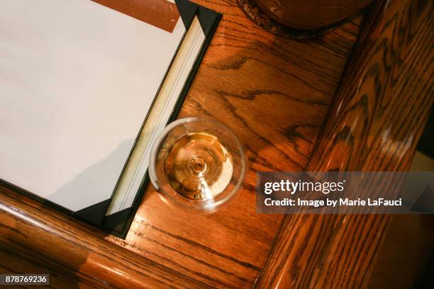 high angle view of wine glass at bar - in tischhöhe stock-fotos und bilder