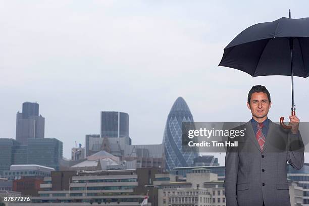 mann with umbrella city scape - portrait mann business stock pictures, royalty-free photos & images