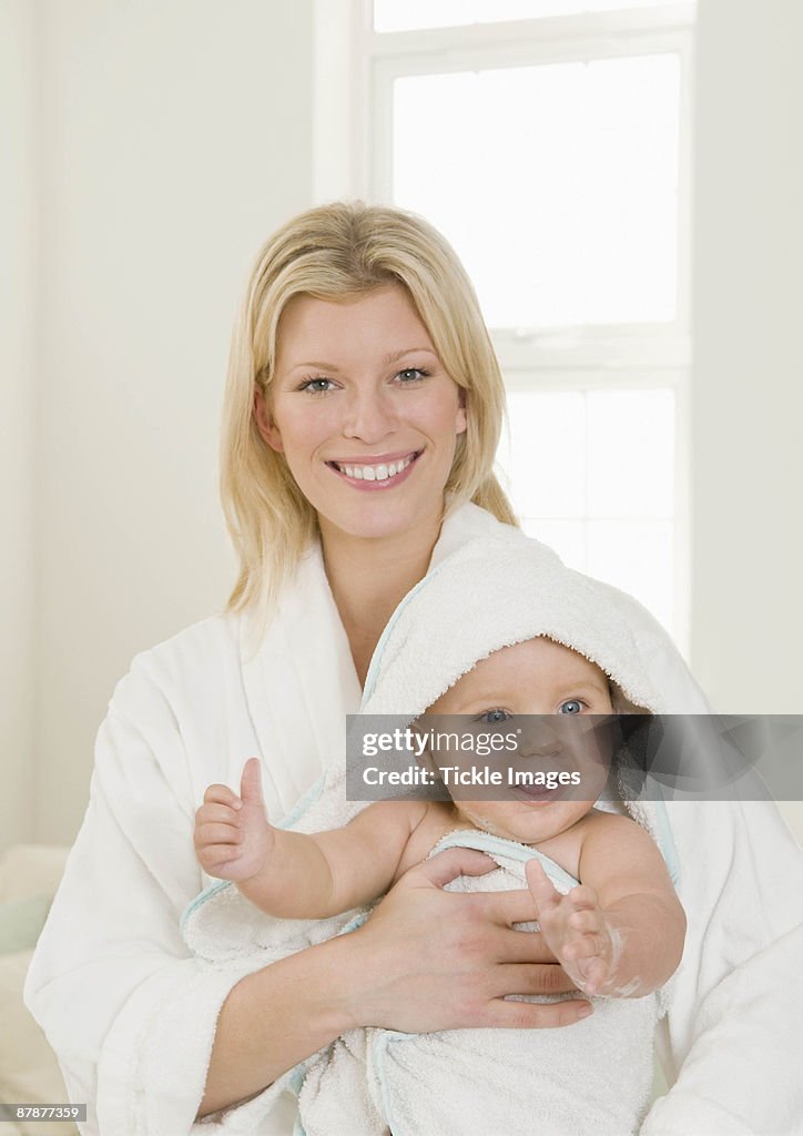 A mother holding her baby in a towel
