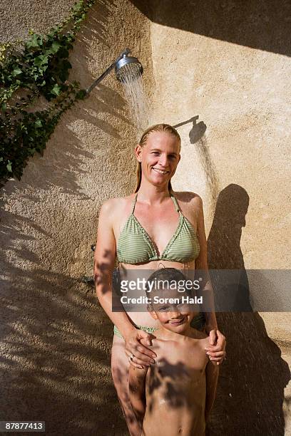 mother and son in shower - woman swimsuit happy normal stock pictures, royalty-free photos & images