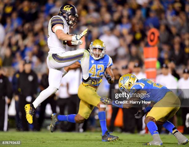 Patrick Laird of the California Golden Bears jumps over Will Lockett of the UCLA Bruins during the third quarter at Rose Bowl on November 24, 2017 in...
