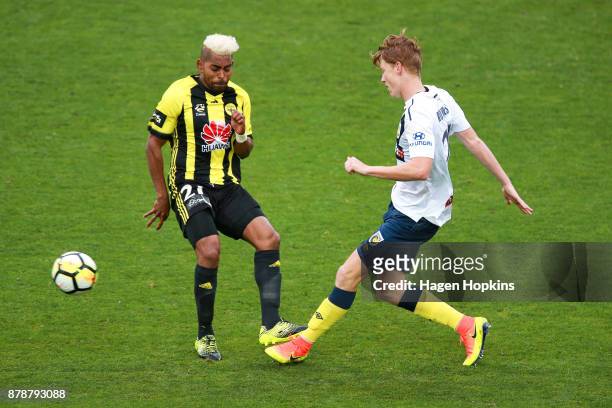Kye Rowles of the Mariners passes under pressure from Roy Krishna of the Phoenix during the round eight A-League match between the Wellington Phoenix...