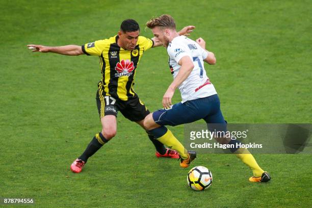Andrew Hoole of the Mariners is challenged by Ali Abbas of the Phoenix during the round eight A-League match between the Wellington Phoenix and the...