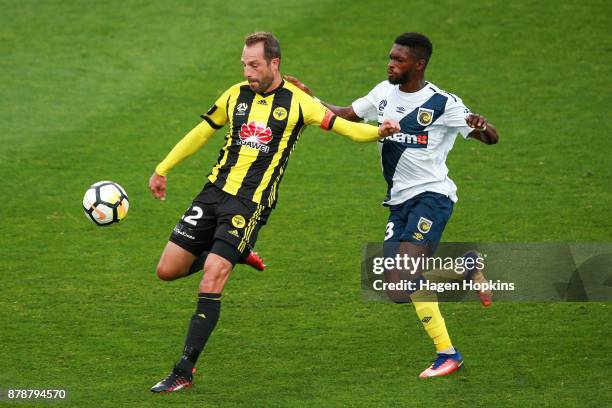 Andrew Durante of the Phoenix holds off the challenge of Kwabena Appiah-Kubi of the Mariners during the round eight A-League match between the...