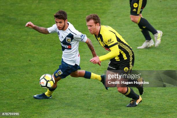 Michael McGlinchey of the Phoenix and Storm Roux of the Mariners compete for the ball during the round eight A-League match between the Wellington...
