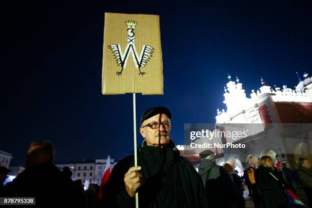 Man holds freedom related banner during a protest at the Main Square against government plans for sweeping changes to Polands judicial system....