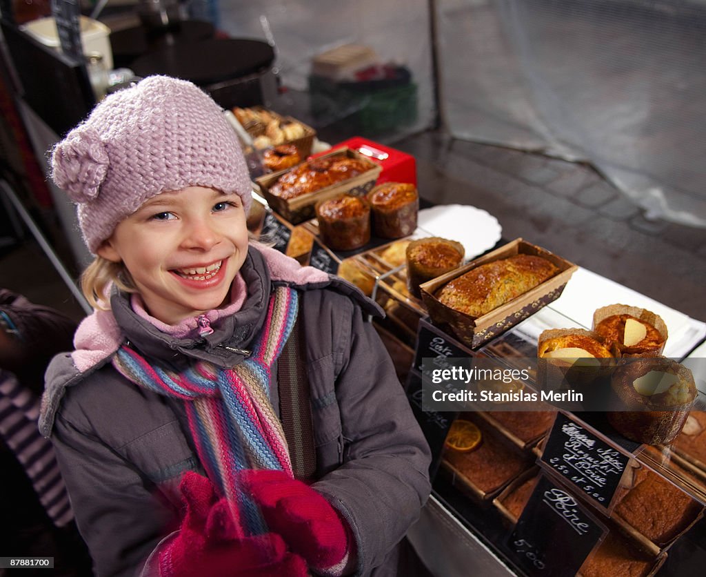 Girl at bakery stall at market