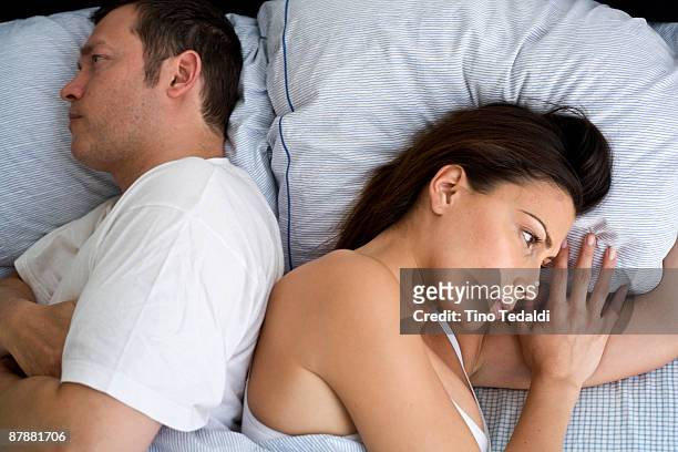 young couple at home in bed - couple relationship difficulties stock pictures, royalty-free photos & images