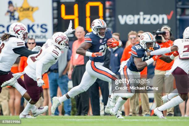 Running back Kerryon Johnson of the Auburn Tigers looks to run the ball past safety Roland Jenkins of the Louisiana Monroe Warhawks at Jordan-Hare...