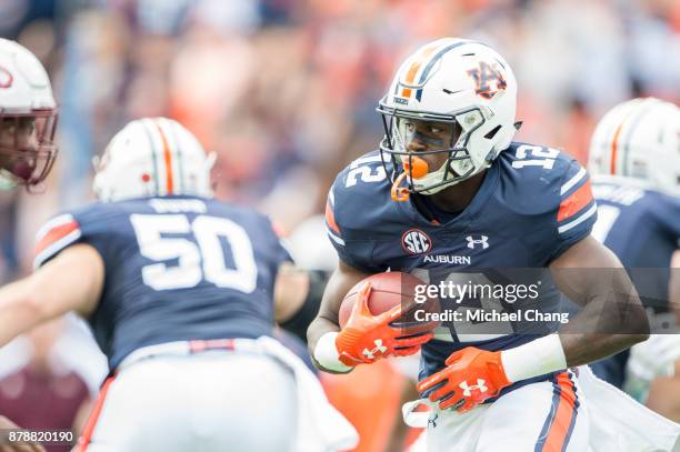 Wide receiver Eli Stove of the Auburn Tigers looks to run the ball through traffic during their game against the Louisiana Monroe Warhawks at...