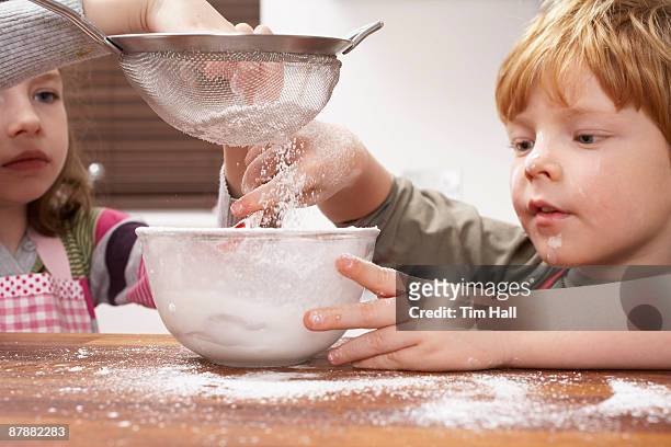 kids at home - powdered sugar sifter fotografías e imágenes de stock
