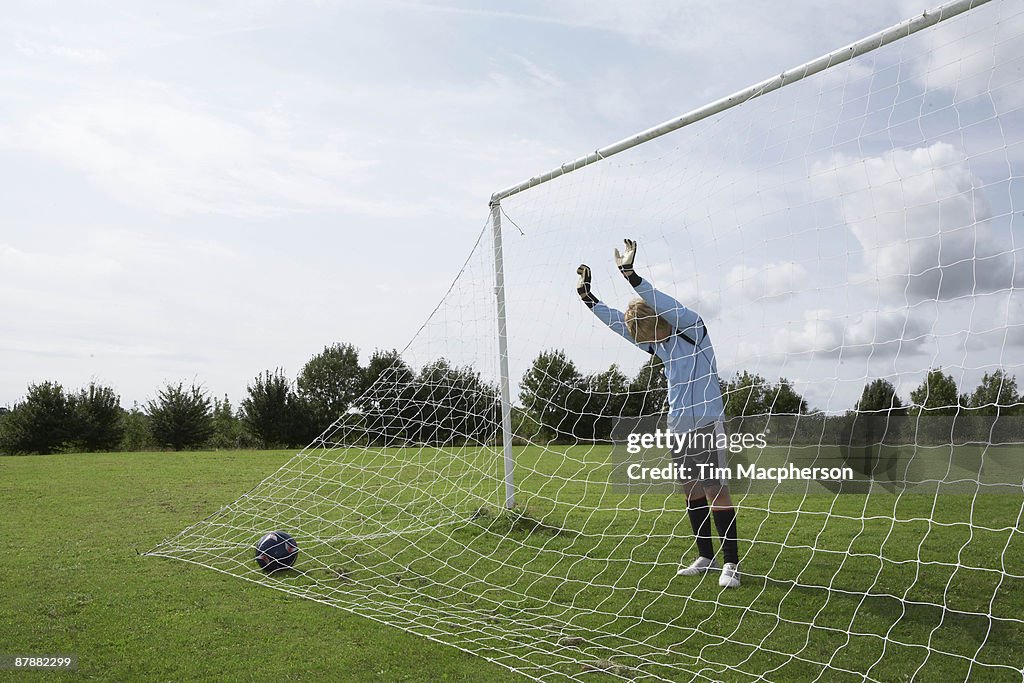 Goalkeeper standing next to net