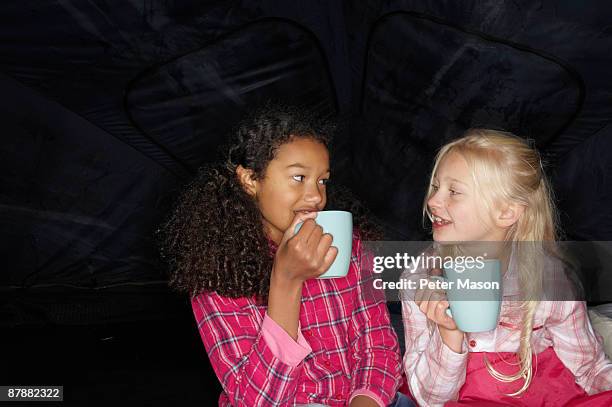 girls with hot drink in tent - only girls stock pictures, royalty-free photos & images