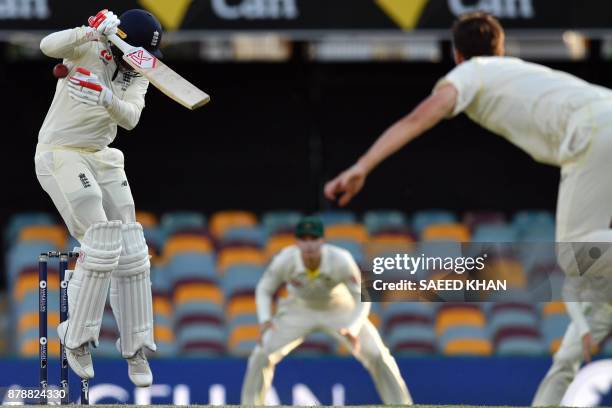 England's batsman Mark Stoneman avoids a bouncer delivery by Australia's paceman Pat Cummins on the third day of the first cricket Ashes Test between...