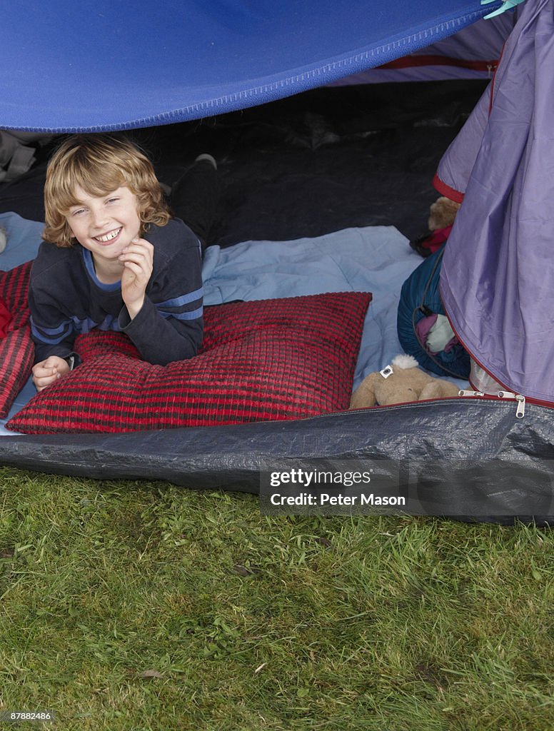 Boy looking out of tent