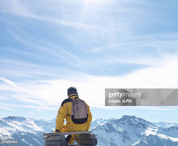 man sitting on bench on mountain top - salzburger land stock pictures, royalty-free photos & images