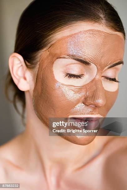 woman with face mask on - clay mask ストックフォトと画像