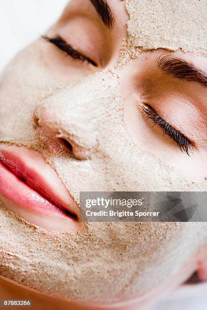 woman with face mask - clay mask ストックフォトと画像