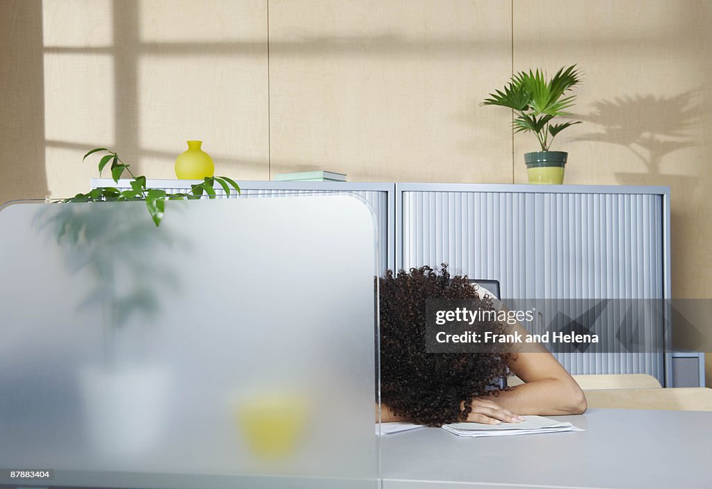 Woman asleep at desk in office