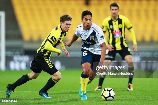 Tom Hiariej of the Mariners makes a break from Michael McGlinchey of the Phoenix during the round eight A-League match between the Wellington Phoenix...