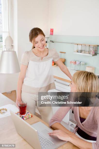 women in kitchen talking - three quarter length stock pictures, royalty-free photos & images