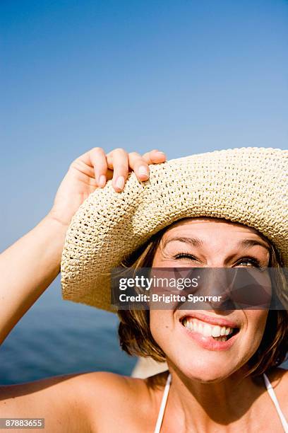 woman with hat smiling - squinting stock pictures, royalty-free photos & images