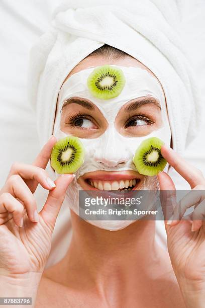 woman with face mask and kiwi fruit - massage funny stock pictures, royalty-free photos & images